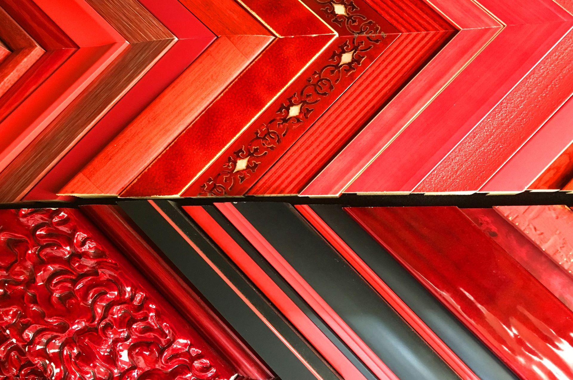 Abstract red geometric pattern with zigzag stripes, glossy textures, and metallic accents