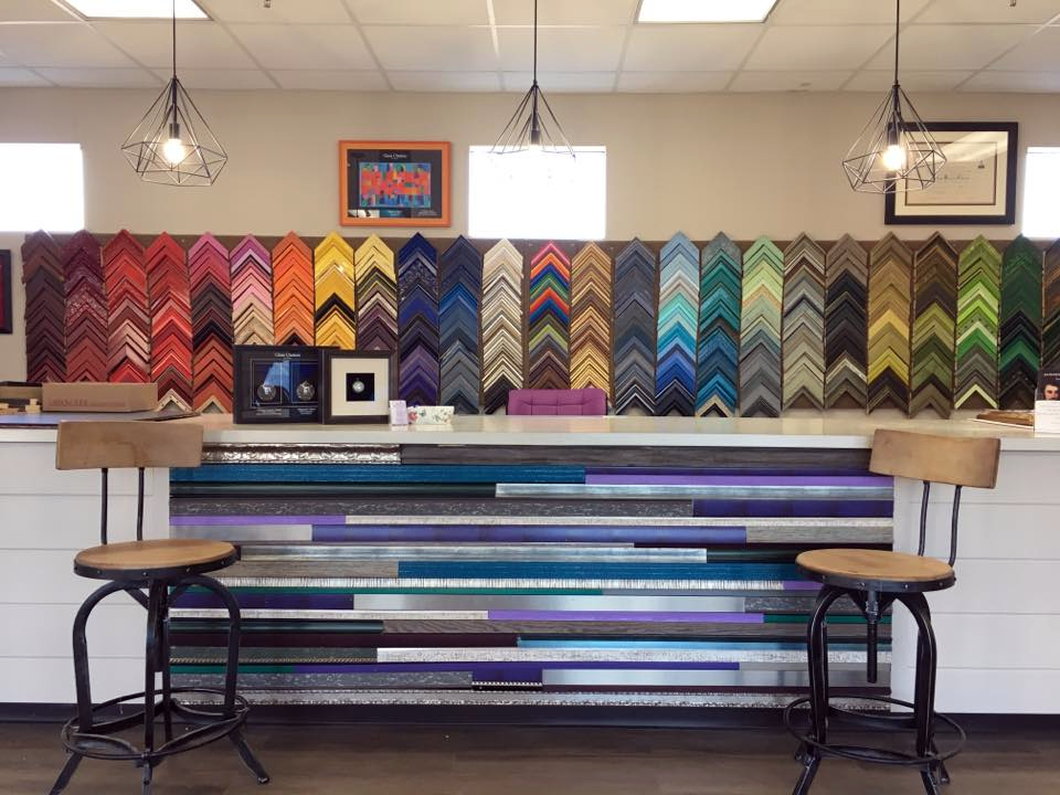 Colorful zigzag-patterned wall behind a bar counter with stools in a cozy café or restaurant interior