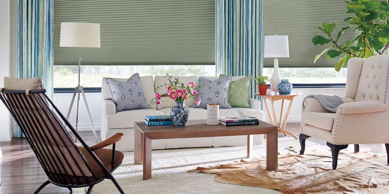 A sitting area with green and blue drapery on the windows