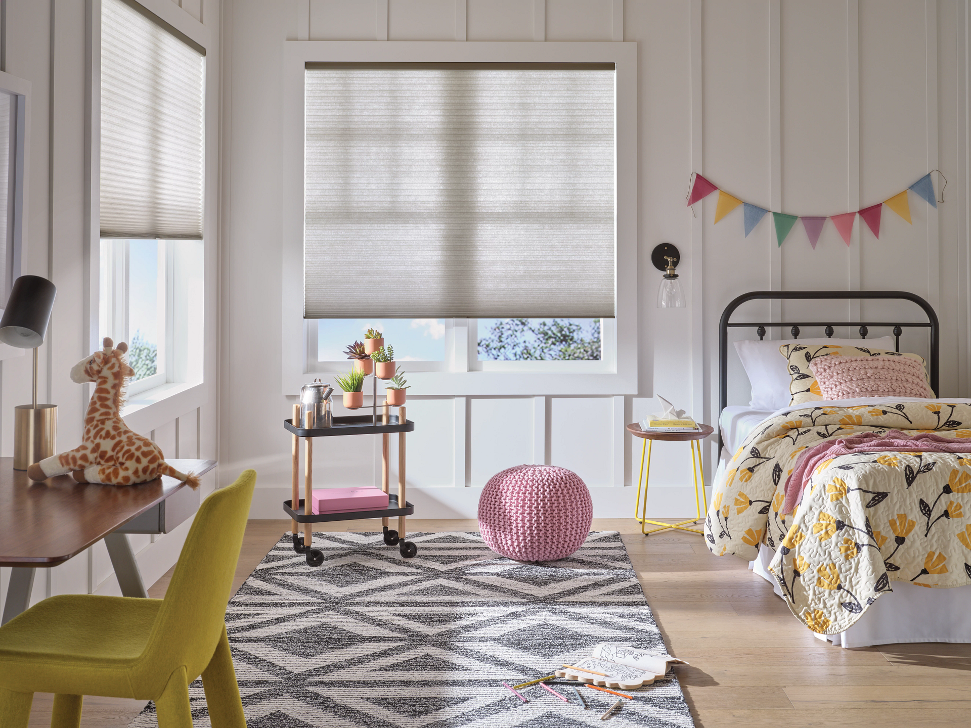 A child 's bedroom with a bed , desk , chairs and a rug.