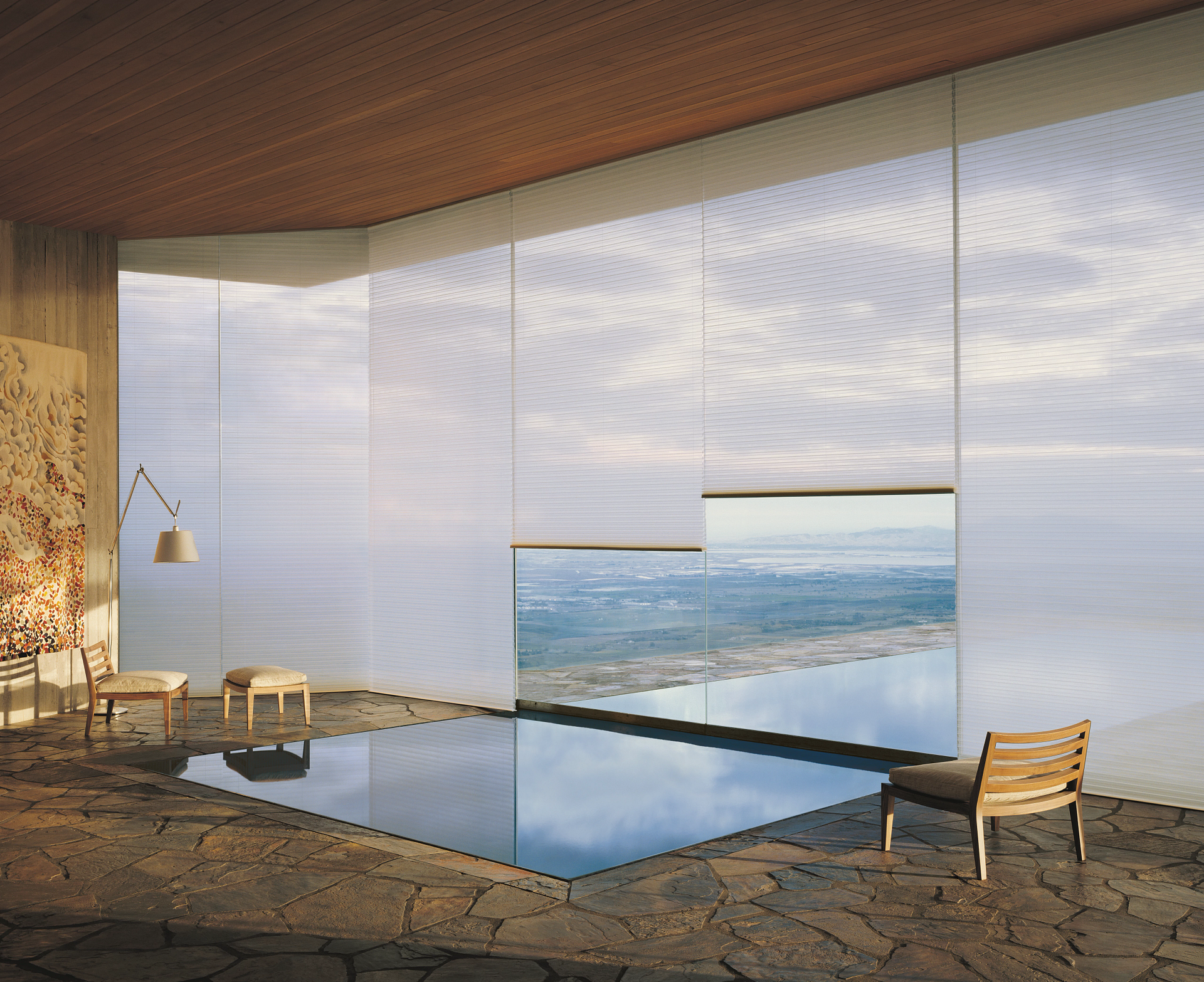 A room with a swimming pool and a view of the ocean