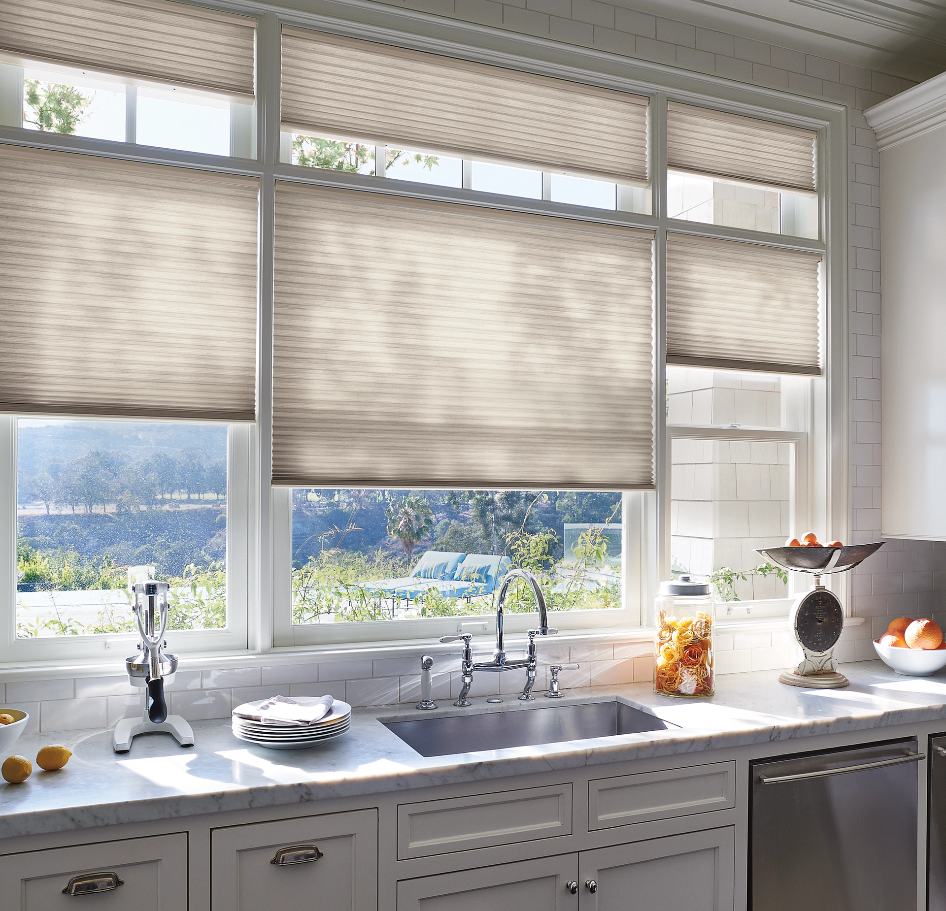 A kitchen with a sink and a window with blinds