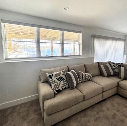 A living room with a couch and a window