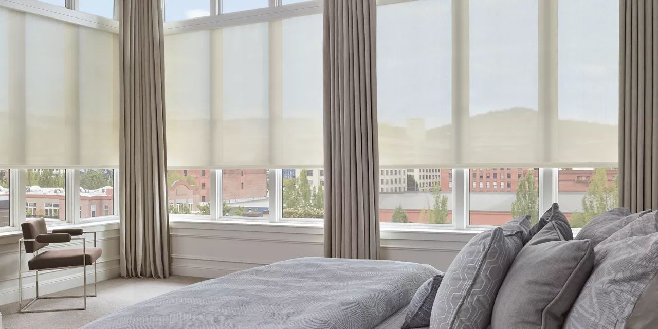 A bedroom with a large bed and lots of windows.