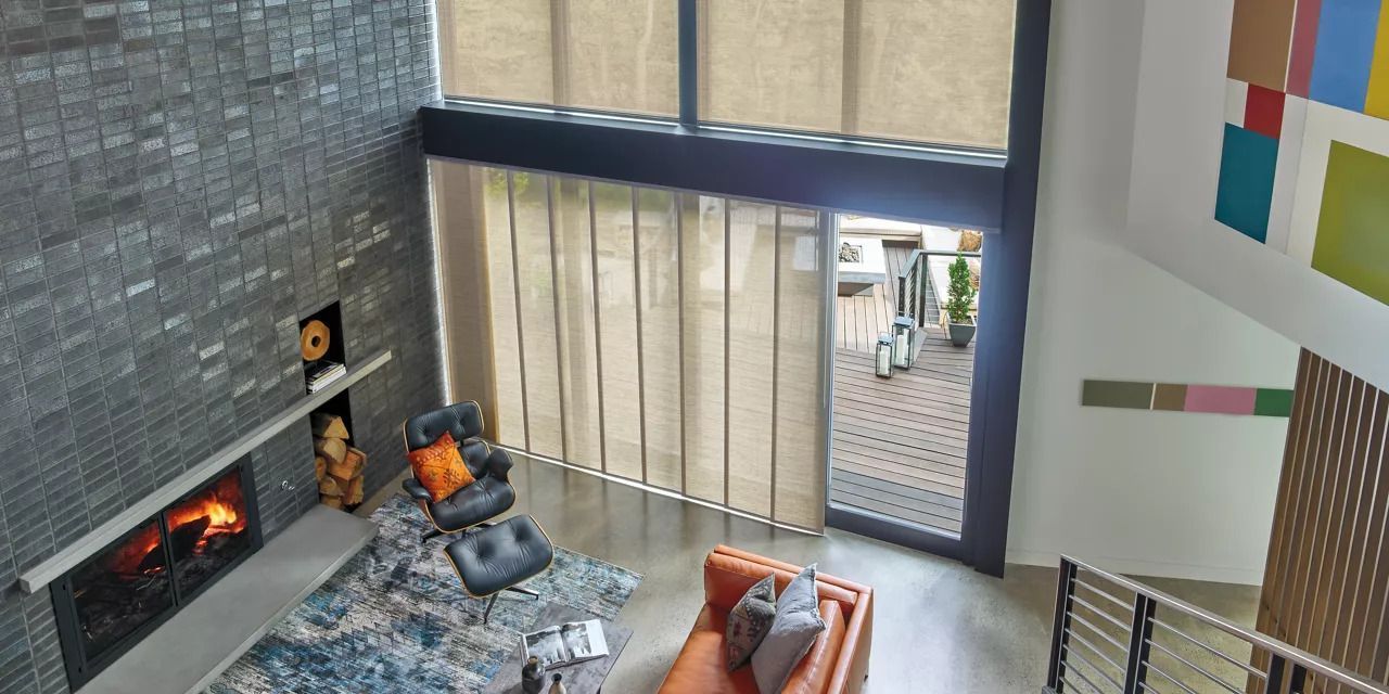 An aerial view of a living room with a fireplace and sliding glass doors.