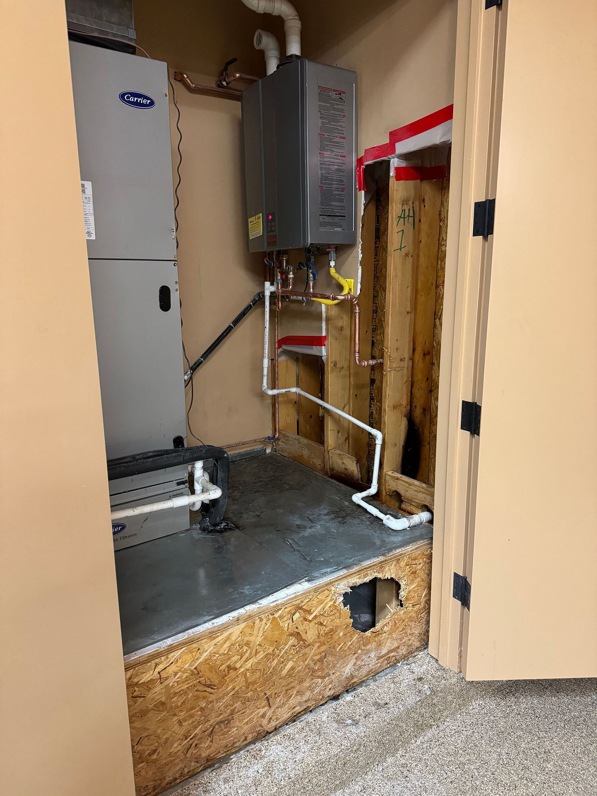 A room with a heater and a water heater in it.