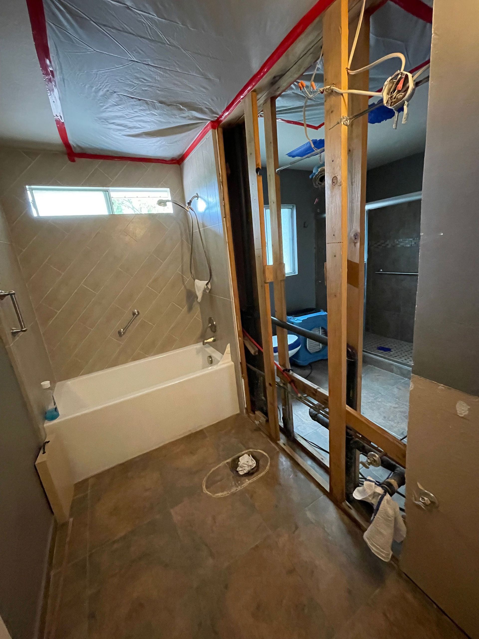 A bathroom under construction with a bathtub and shower.