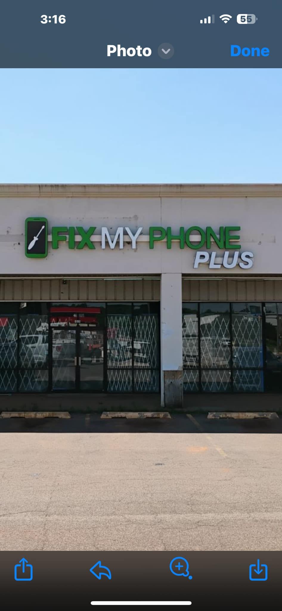 A picture of a store front on a cell phone.