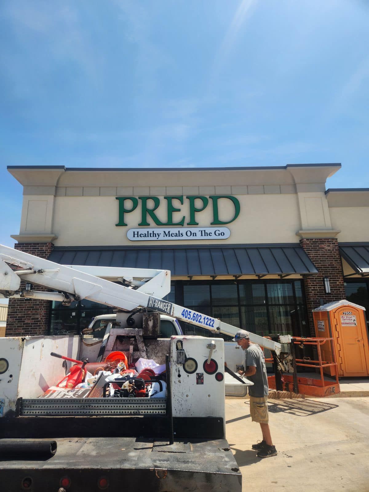 A man is standing in front of a prepd store