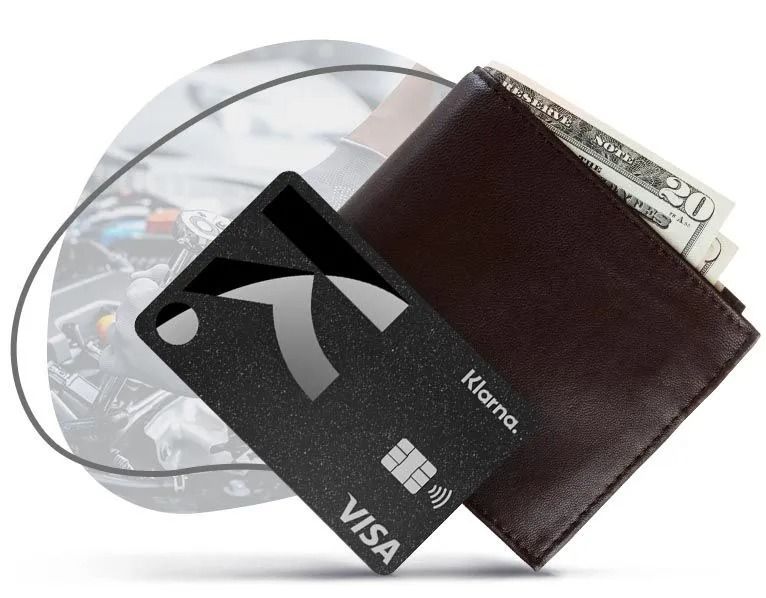 Black credit card and brown wallet with cash on a silver disc background