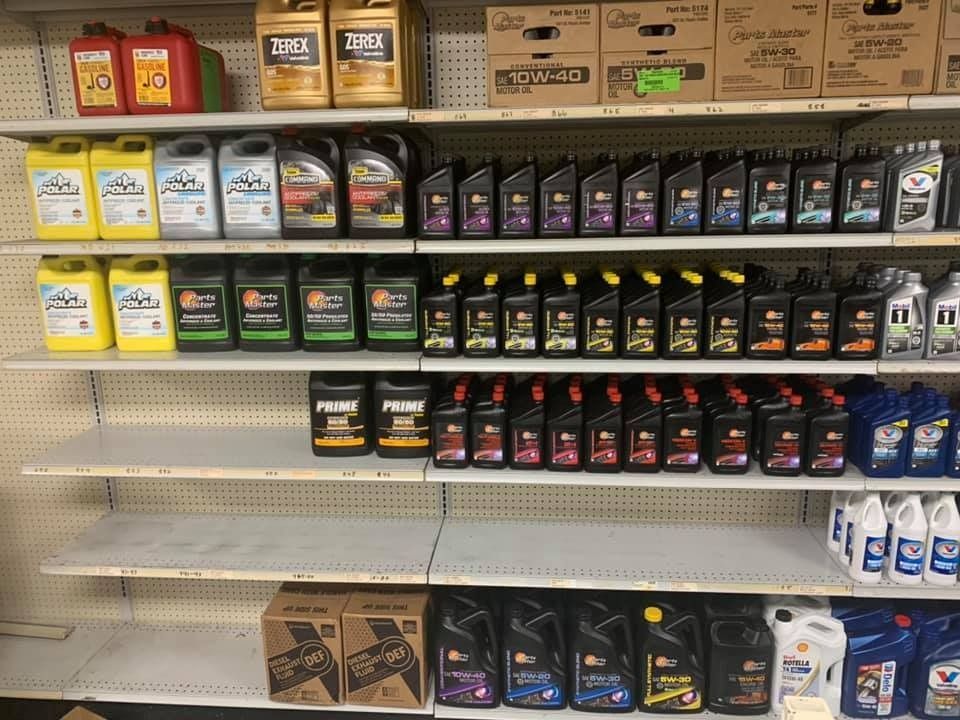 A store shelf filled with lots of bottles of oil.