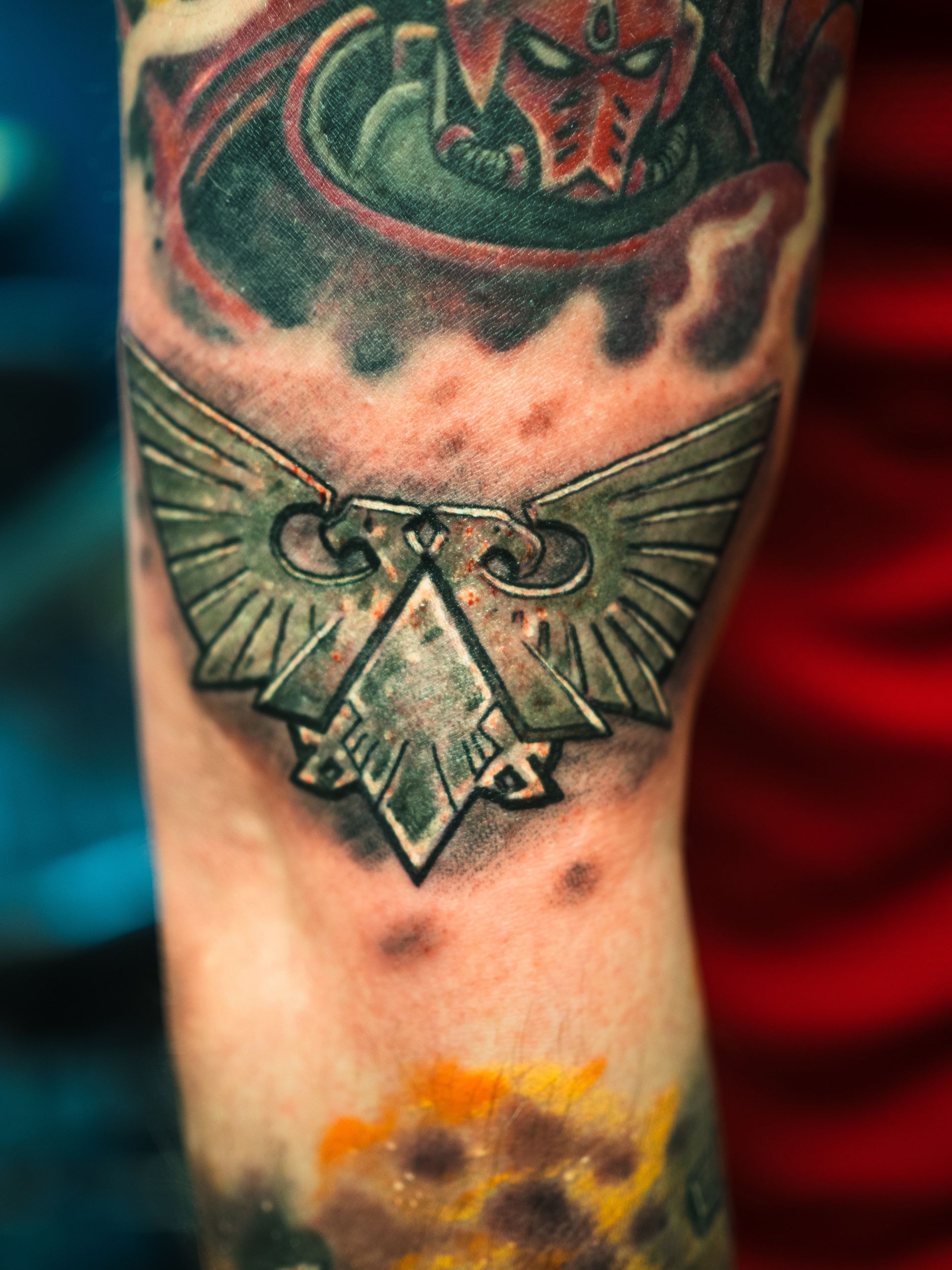 Purple cartoon bat tattoo on skin