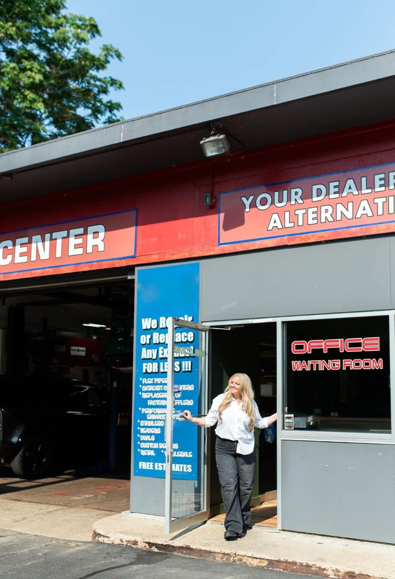 Person standing outside an auto parts store entrance with blue and red signage