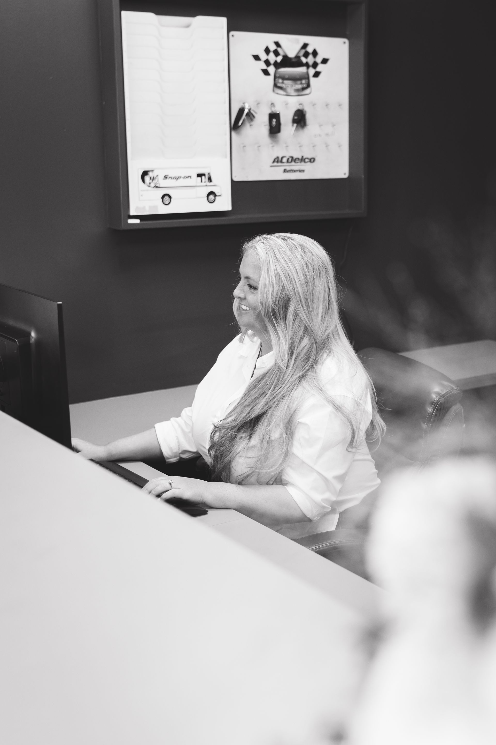 Person seated at a desk working on a computer in an office setting