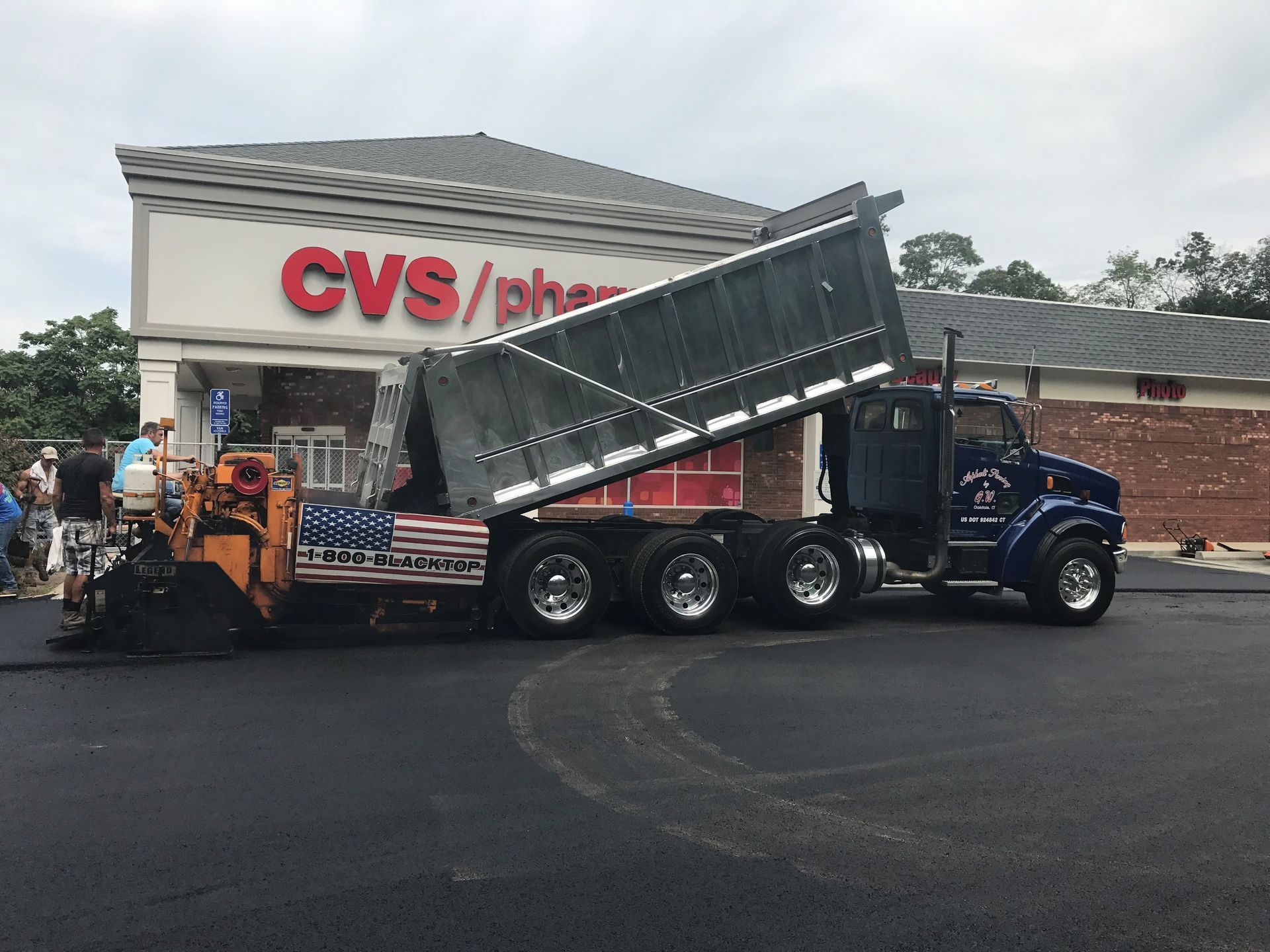 A dump truck is parked in front of a CVS Pharmacy