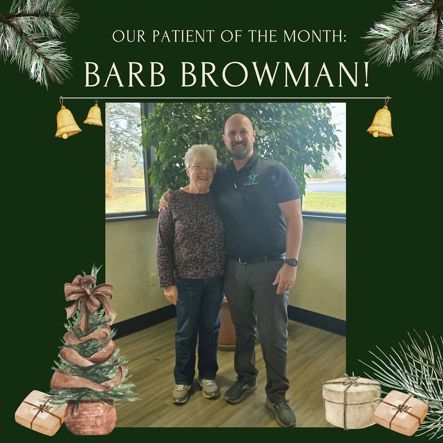 Our patient of the month, Barb Browman, standing with a man in a festive holiday frame