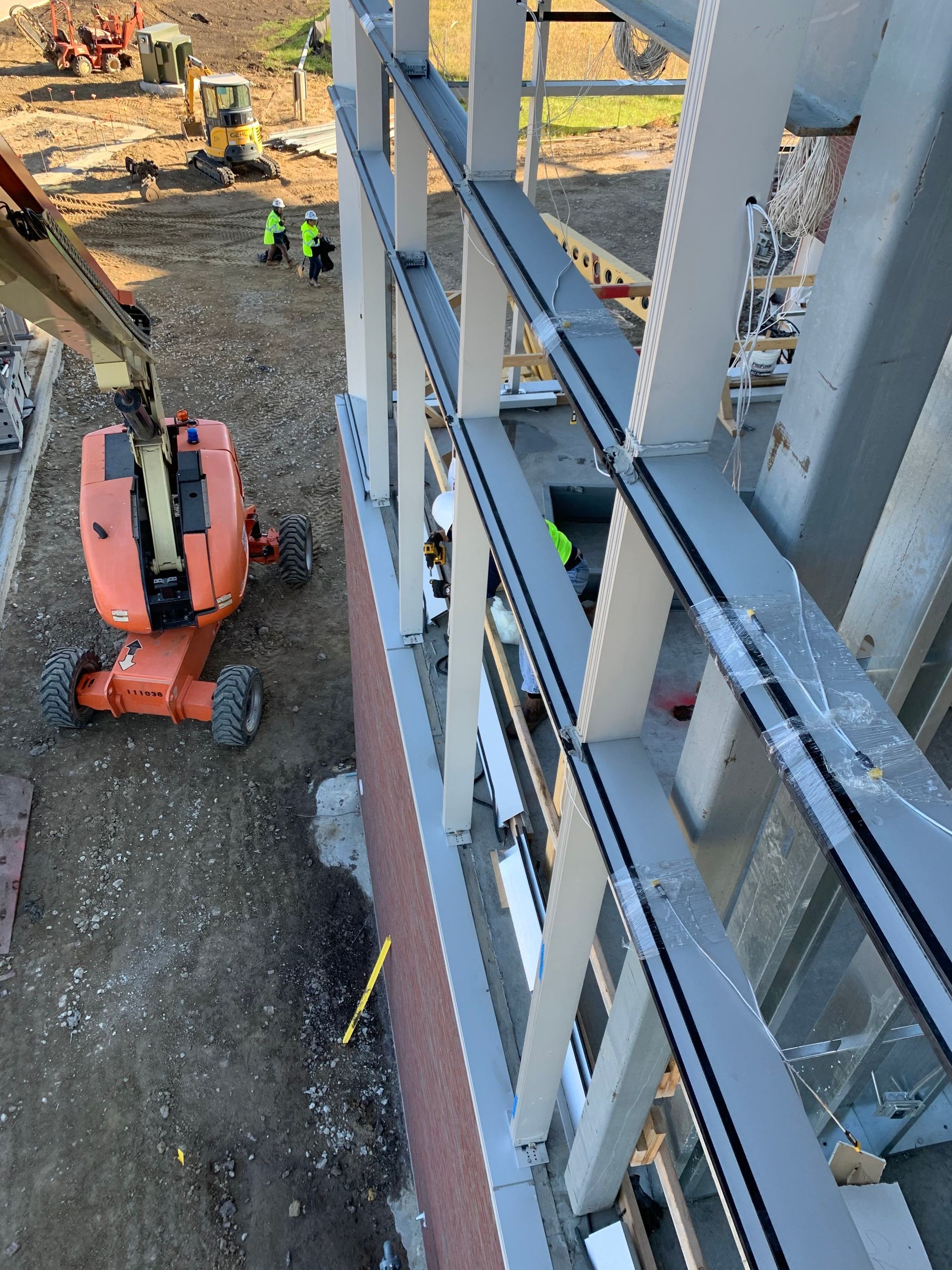 A construction site with a jlg lift in the foreground