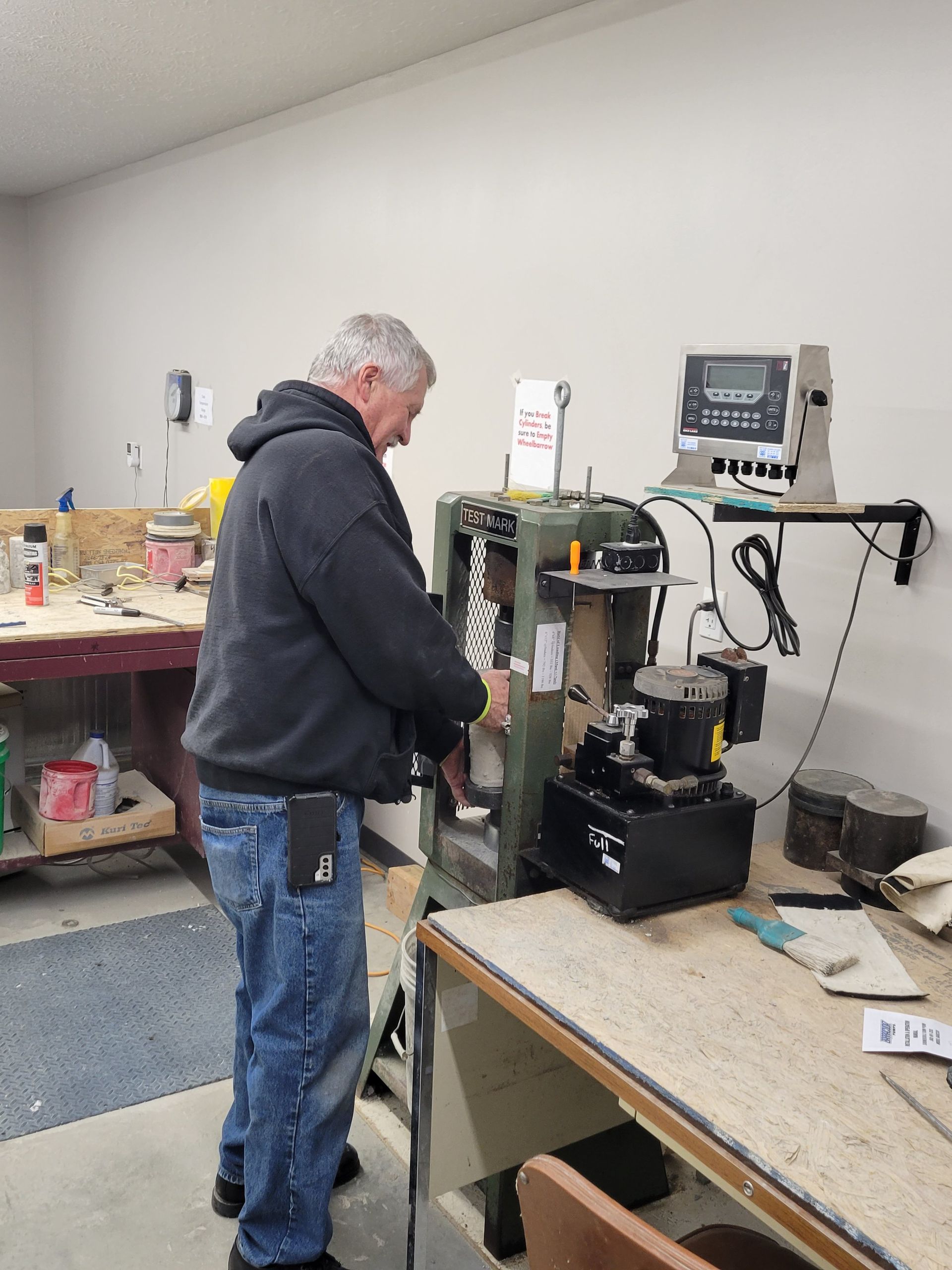 A man is working on a machine in a workshop.