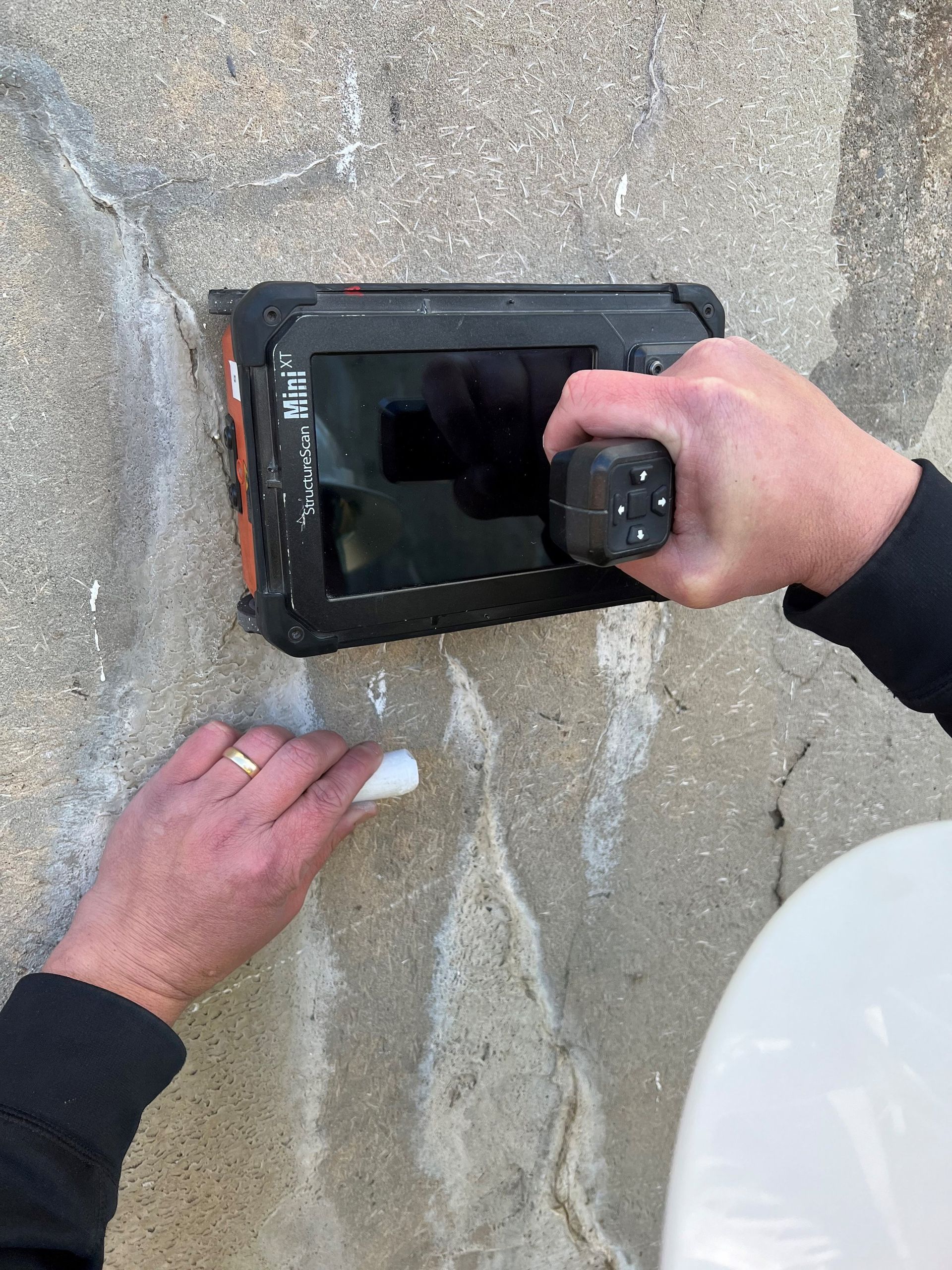 A person is using a tablet to take a picture of a wall