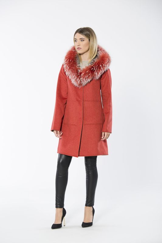 Woman wearing red coat with fur collar, black leggings, and heels.