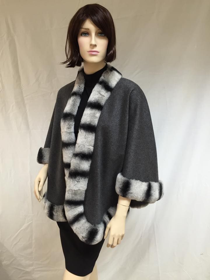 Mannequin wearing a gray cape with chinchilla fur trim.