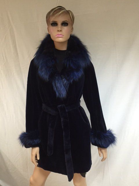 Navy blue fur coat on a mannequin, with a matching fur collar and cuffs, and a belted waist.