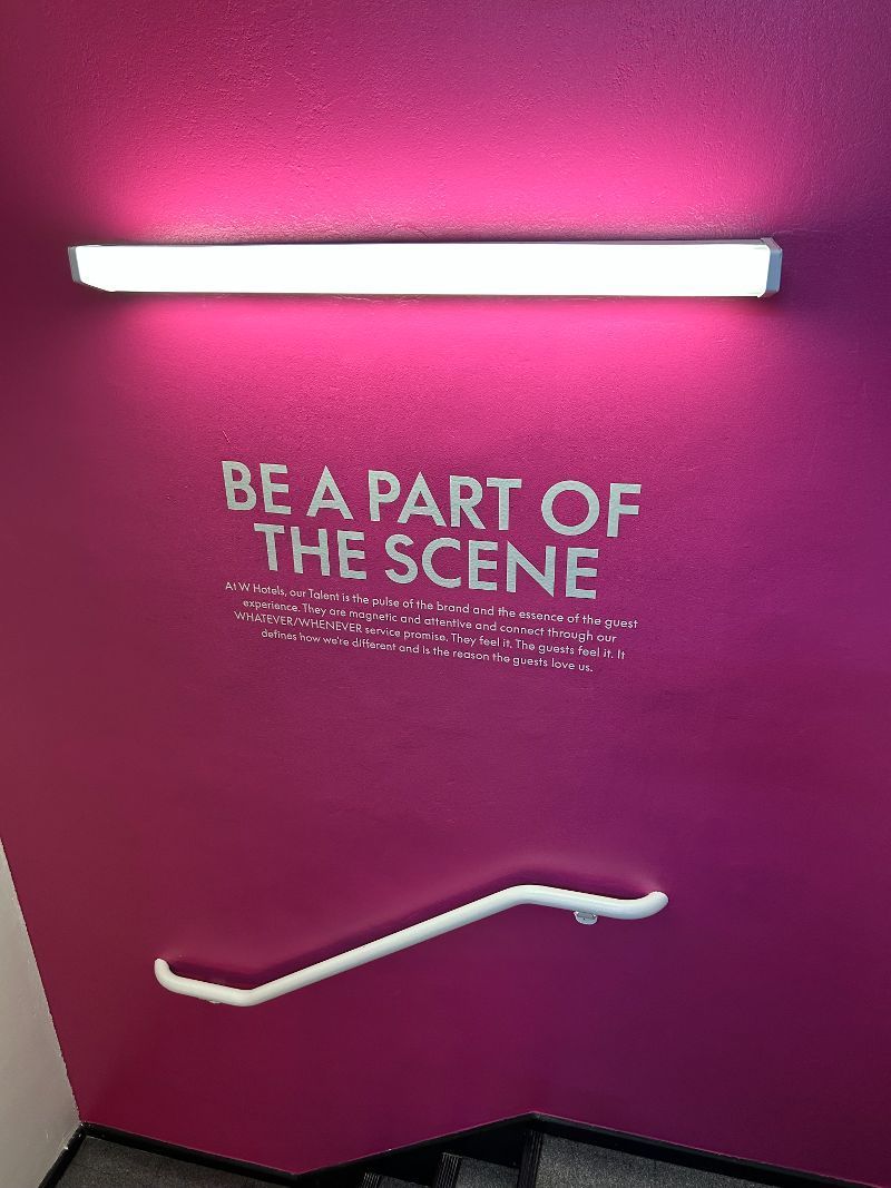A sign on a wall that says `` be a part of the scene ''