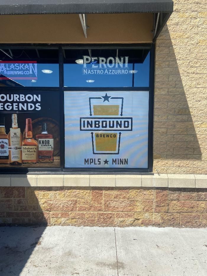 A store window with a sign that says inbound on it.
