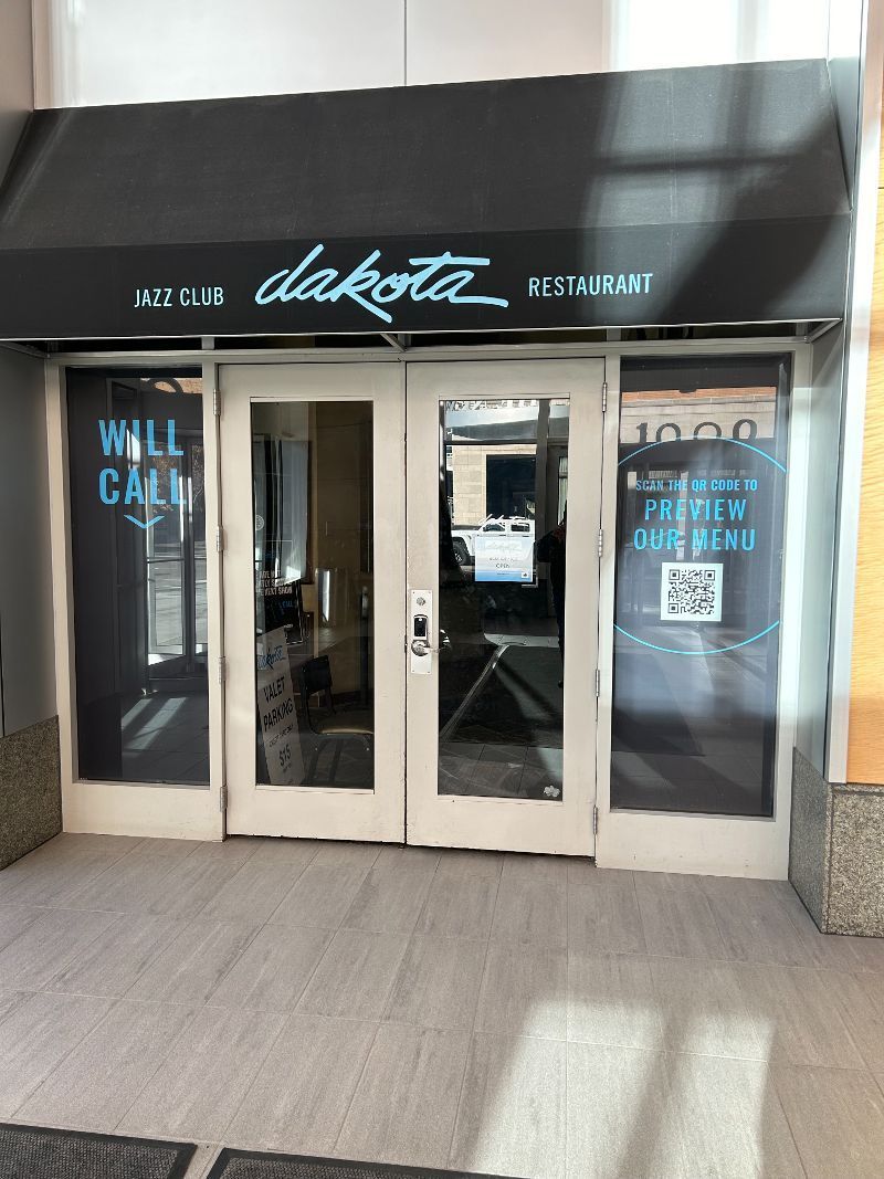 A store front with a black awning and a sign that says `` wall calm ''.