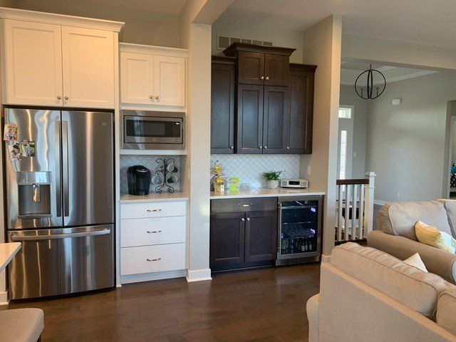A kitchen with stainless steel appliances and white cabinets