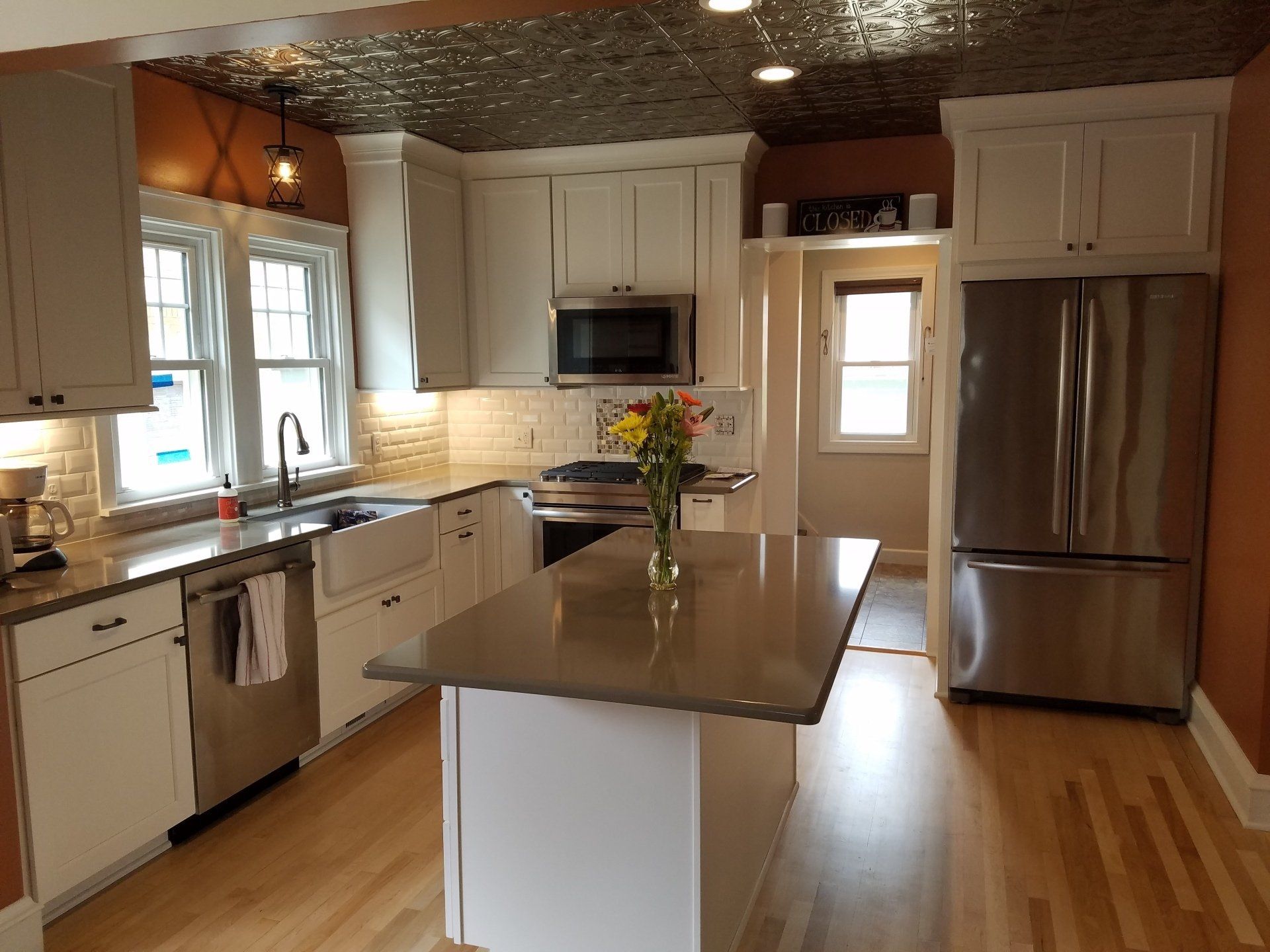 A kitchen with white cabinets and stainless steel appliances