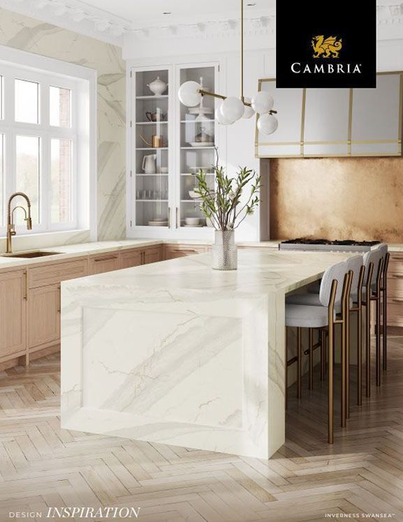 a kitchen with a large island and a sign that says cambria