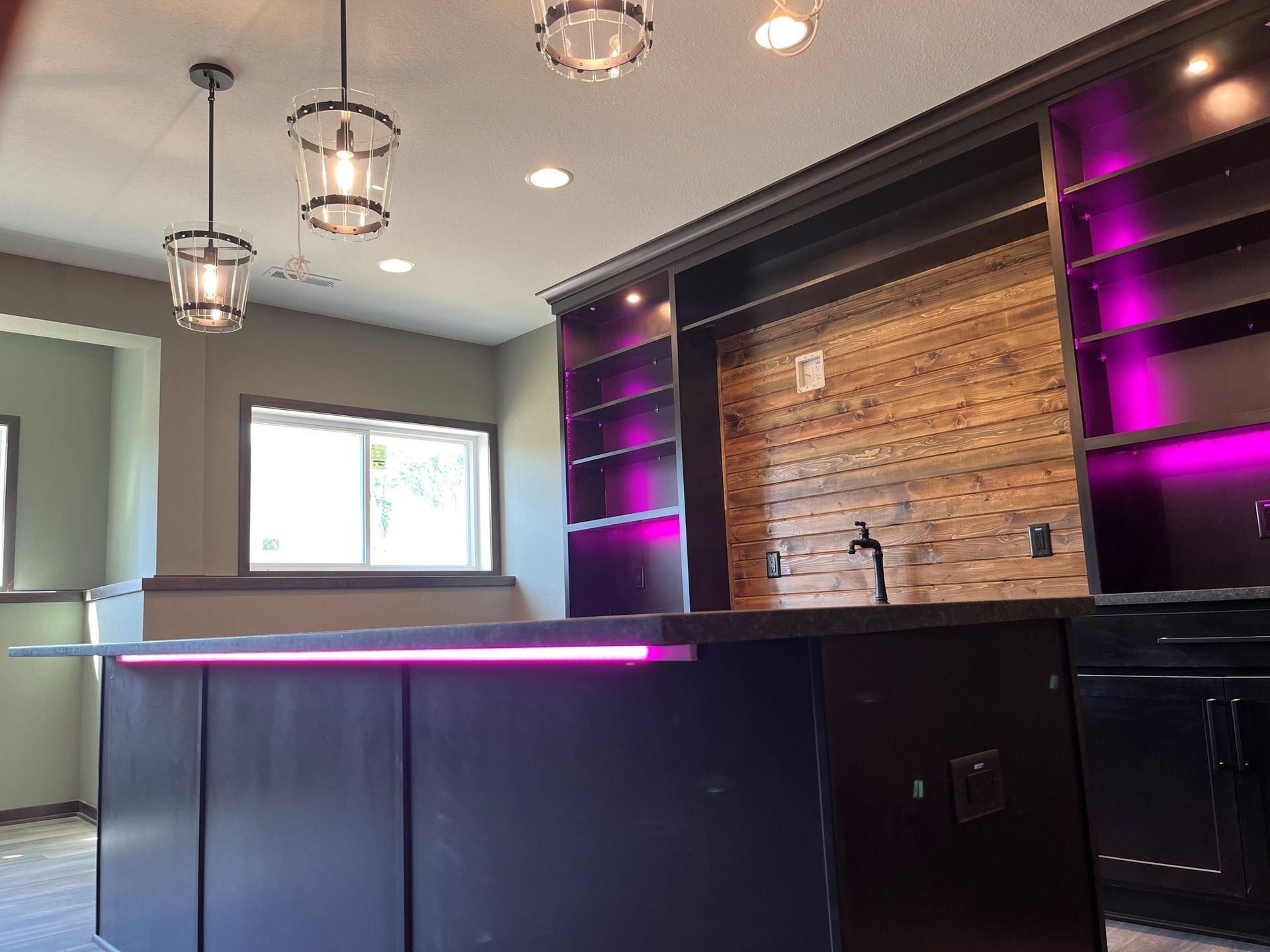 A kitchen with a purple light on the counter.