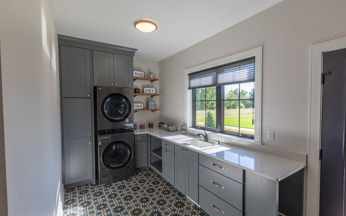 A laundry room with a washer and dryer stacked on top of each other.