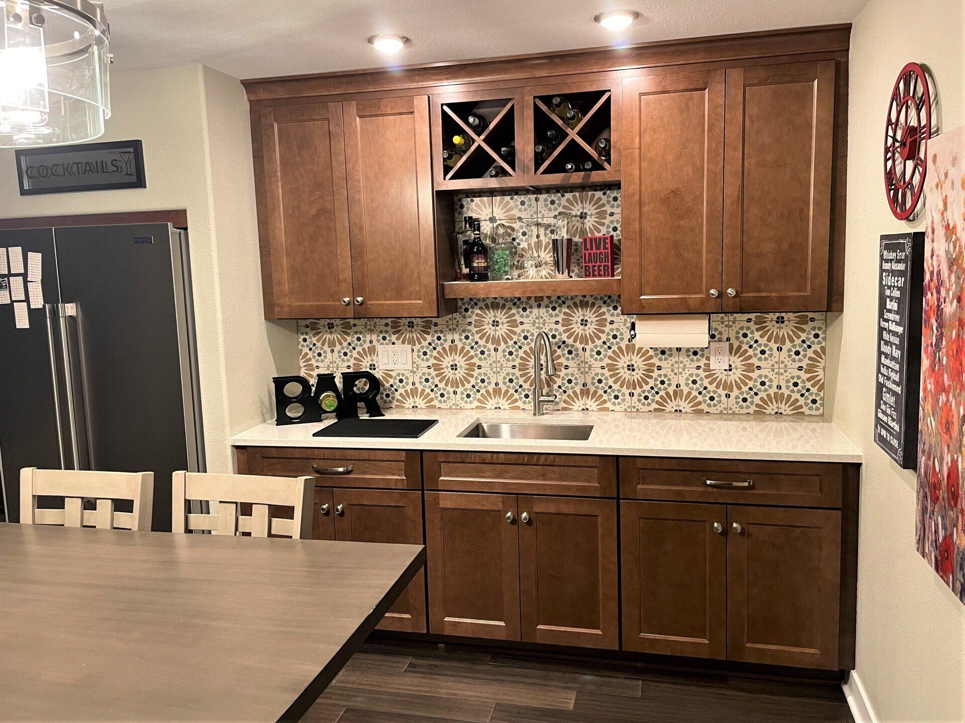 A kitchen with wooden cabinets , a sink , and a table.