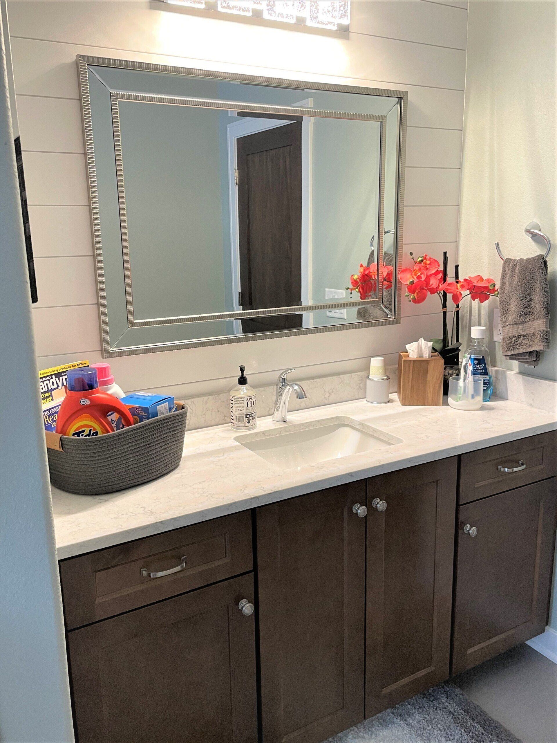 A bathroom with two sinks and a large mirror