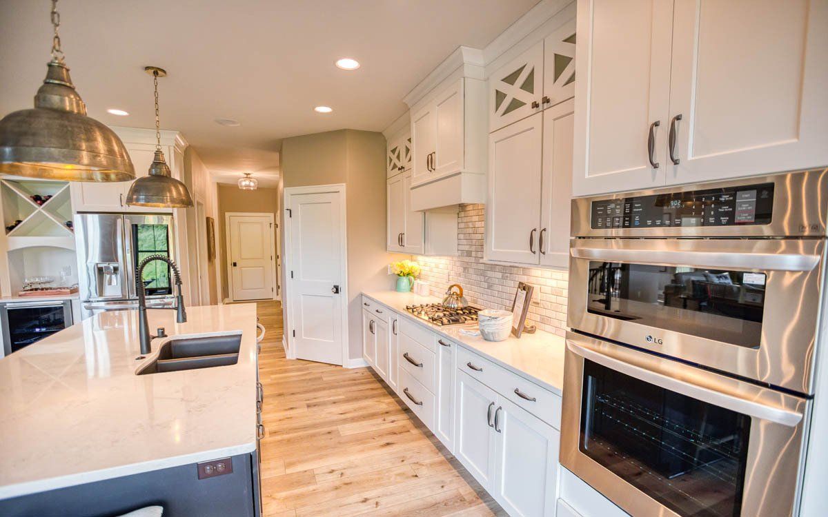 A kitchen with white cabinets and stainless steel appliances.
