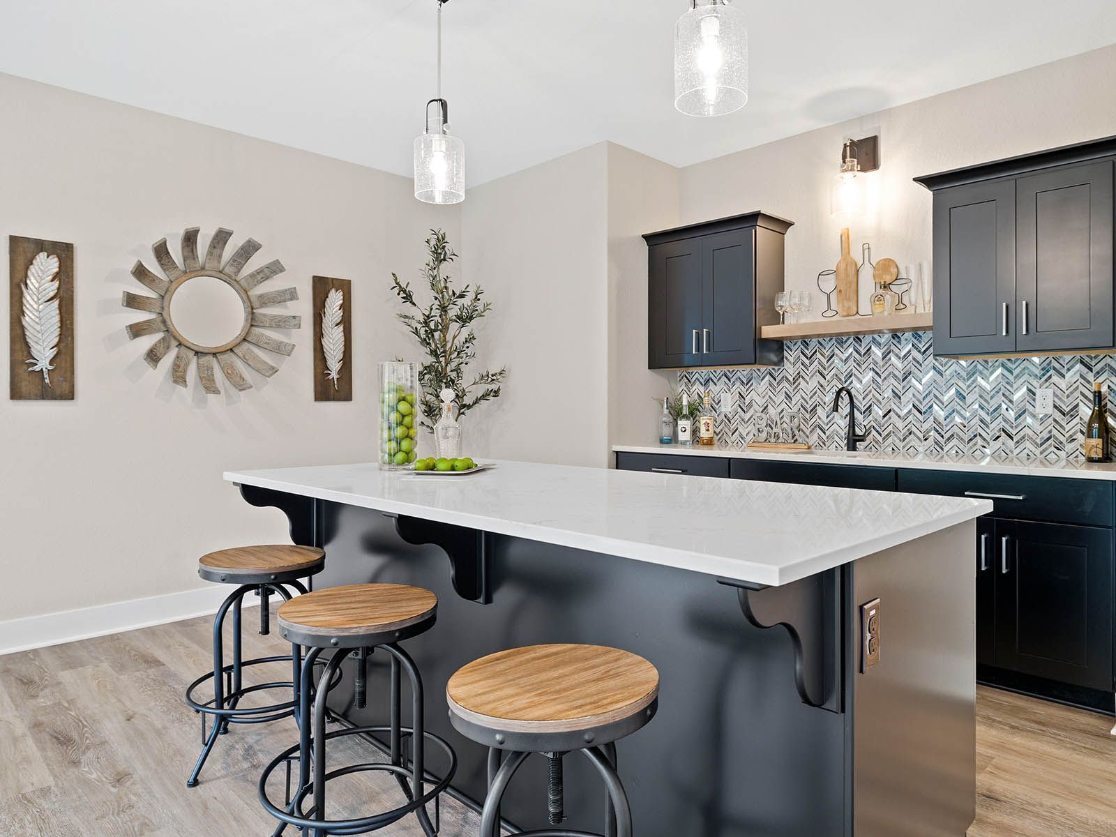 A kitchen with a large island and stools.