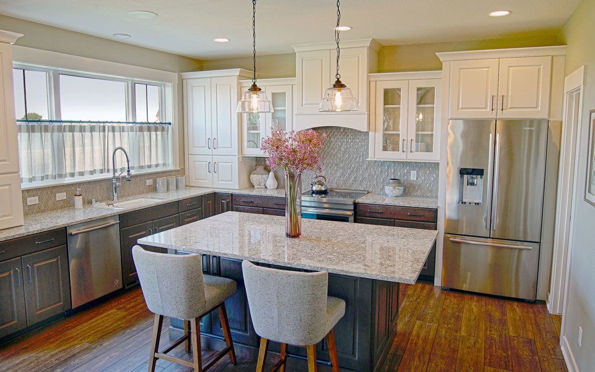 A kitchen with stainless steel appliances and granite counter tops.
