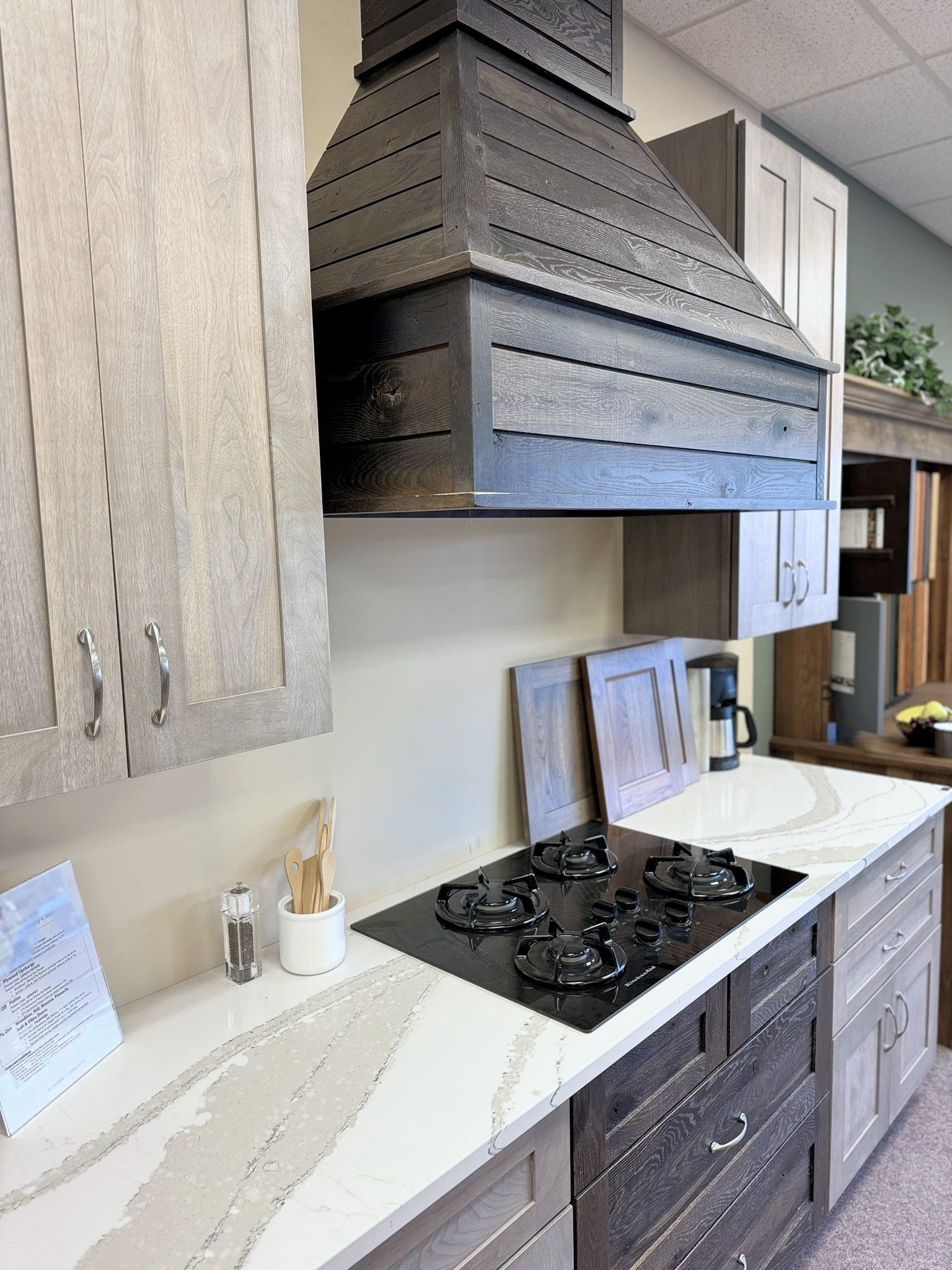 a kitchen with a stove top oven and a hood above it
