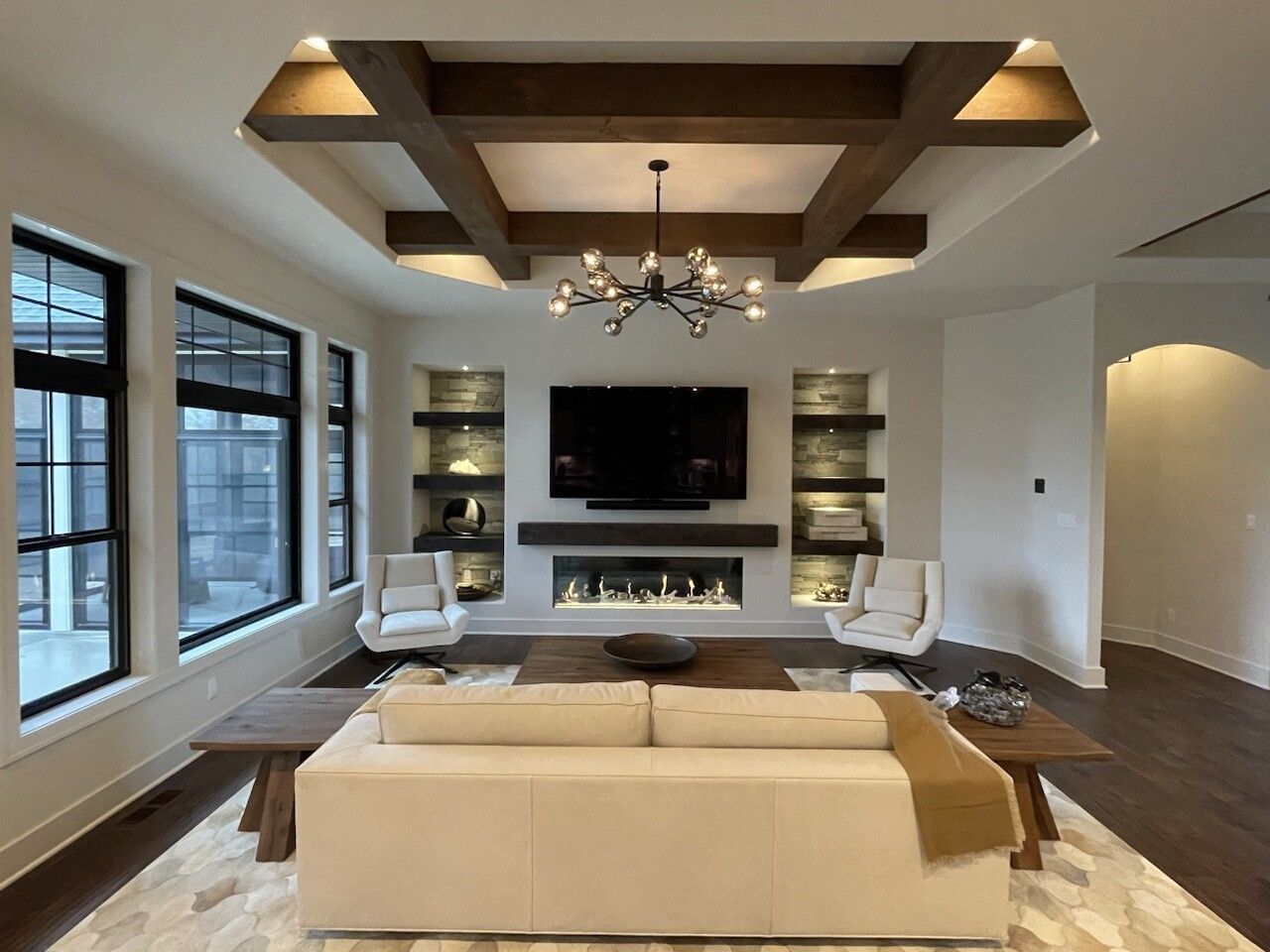 A living room with a fireplace and a flat screen tv