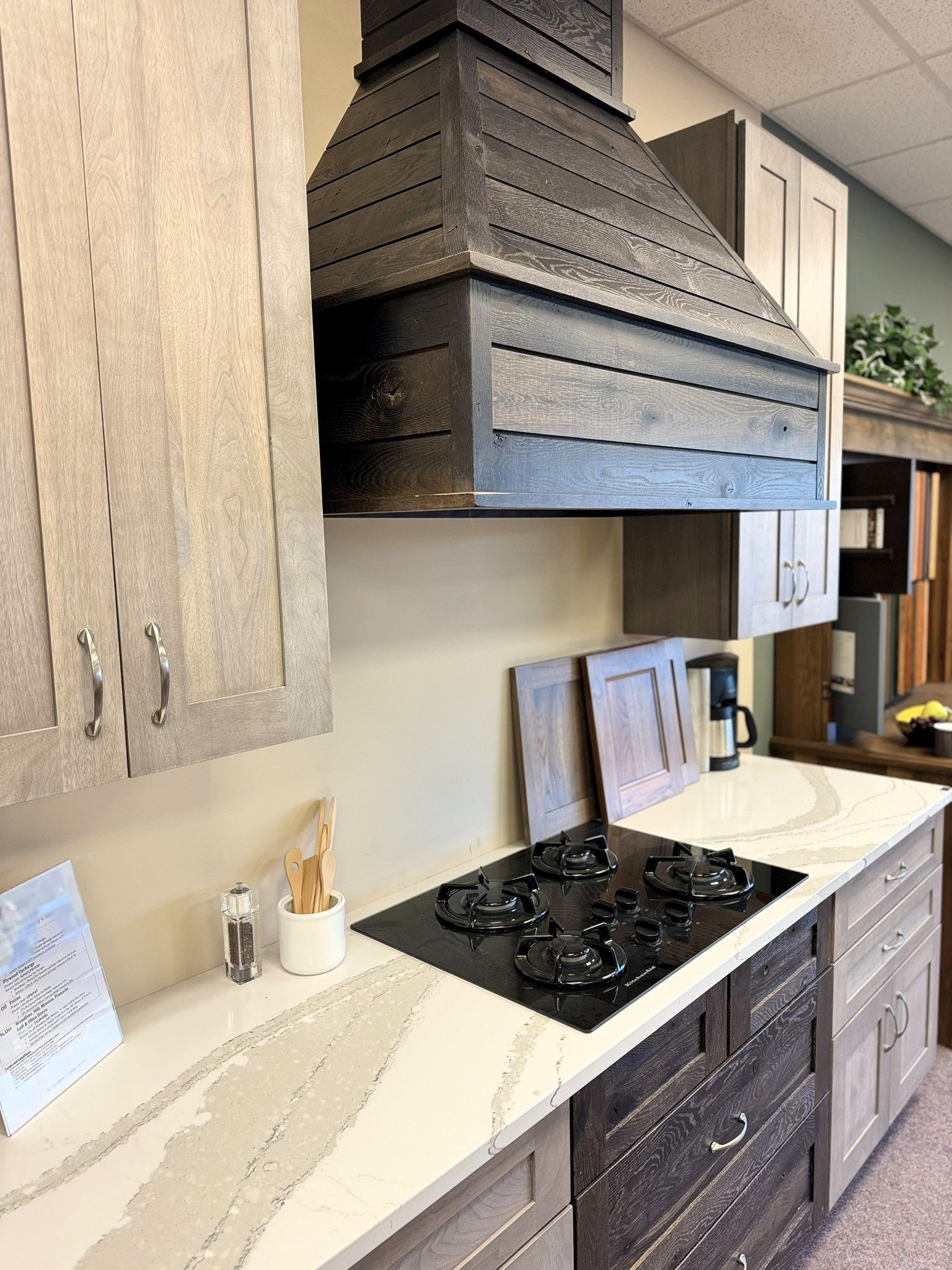 A kitchen with wooden cabinets and a stove top oven.