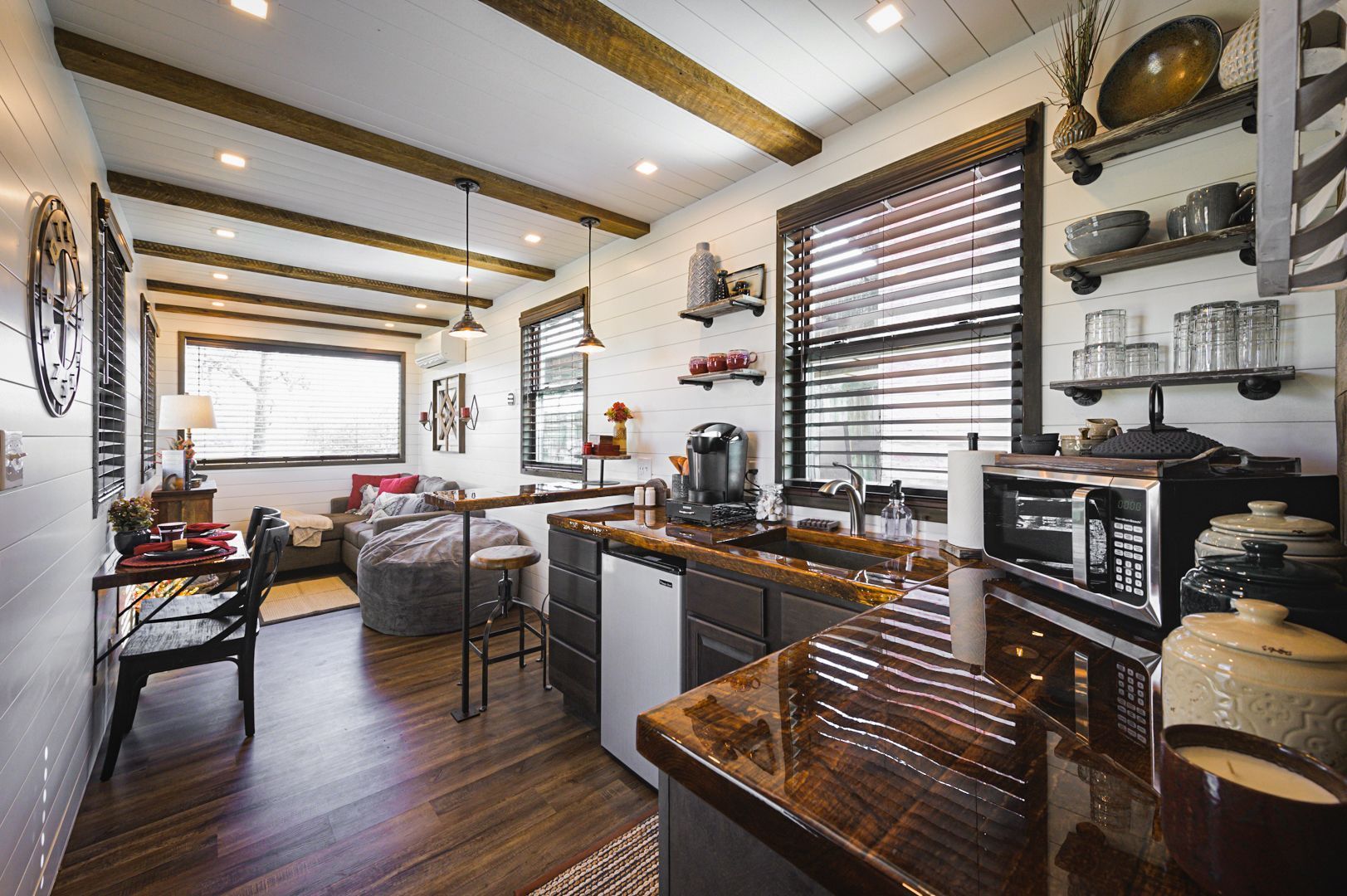 A dining area with a table and chairs and a couch.