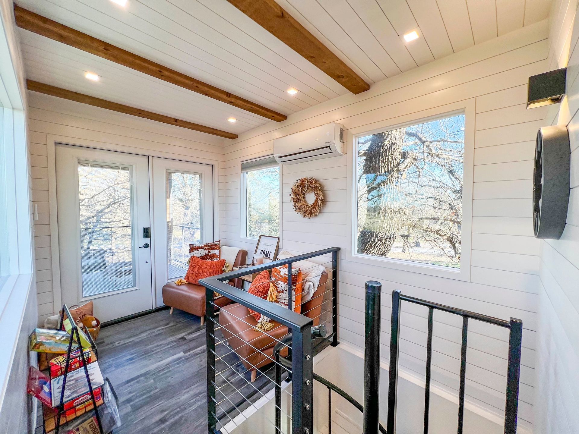 A living room with a couch and stairs leading up to the second floor.