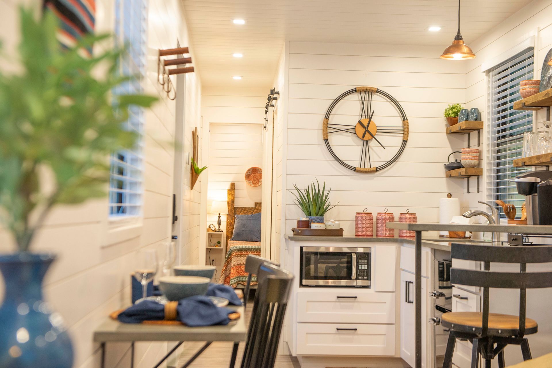 A kitchen in a small house with a chair and a table.
