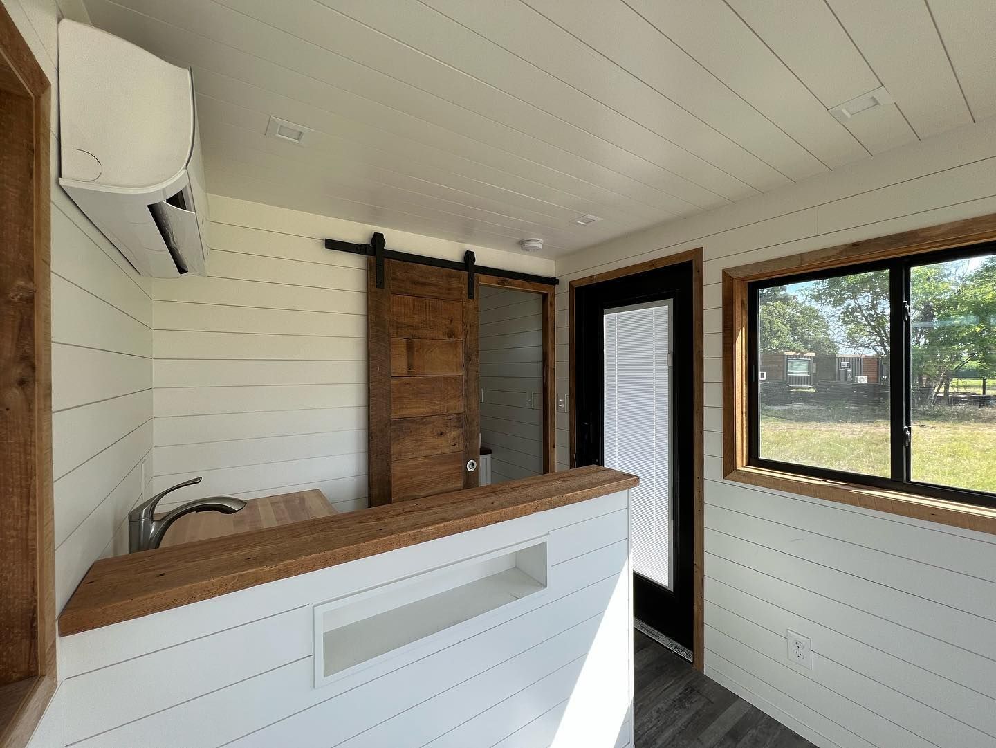 A kitchen with a sliding barn door and a sink.