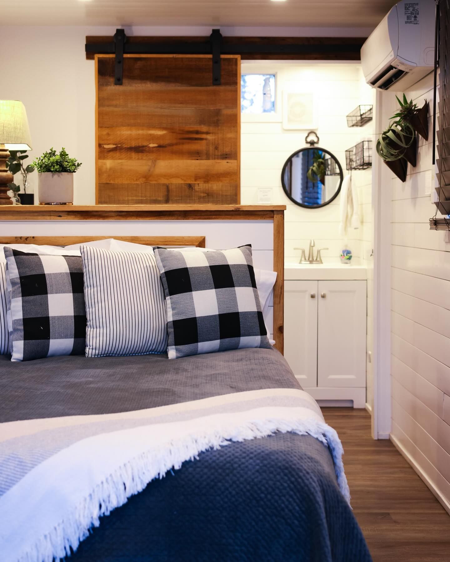 A bedroom with a bed and a sliding barn door.