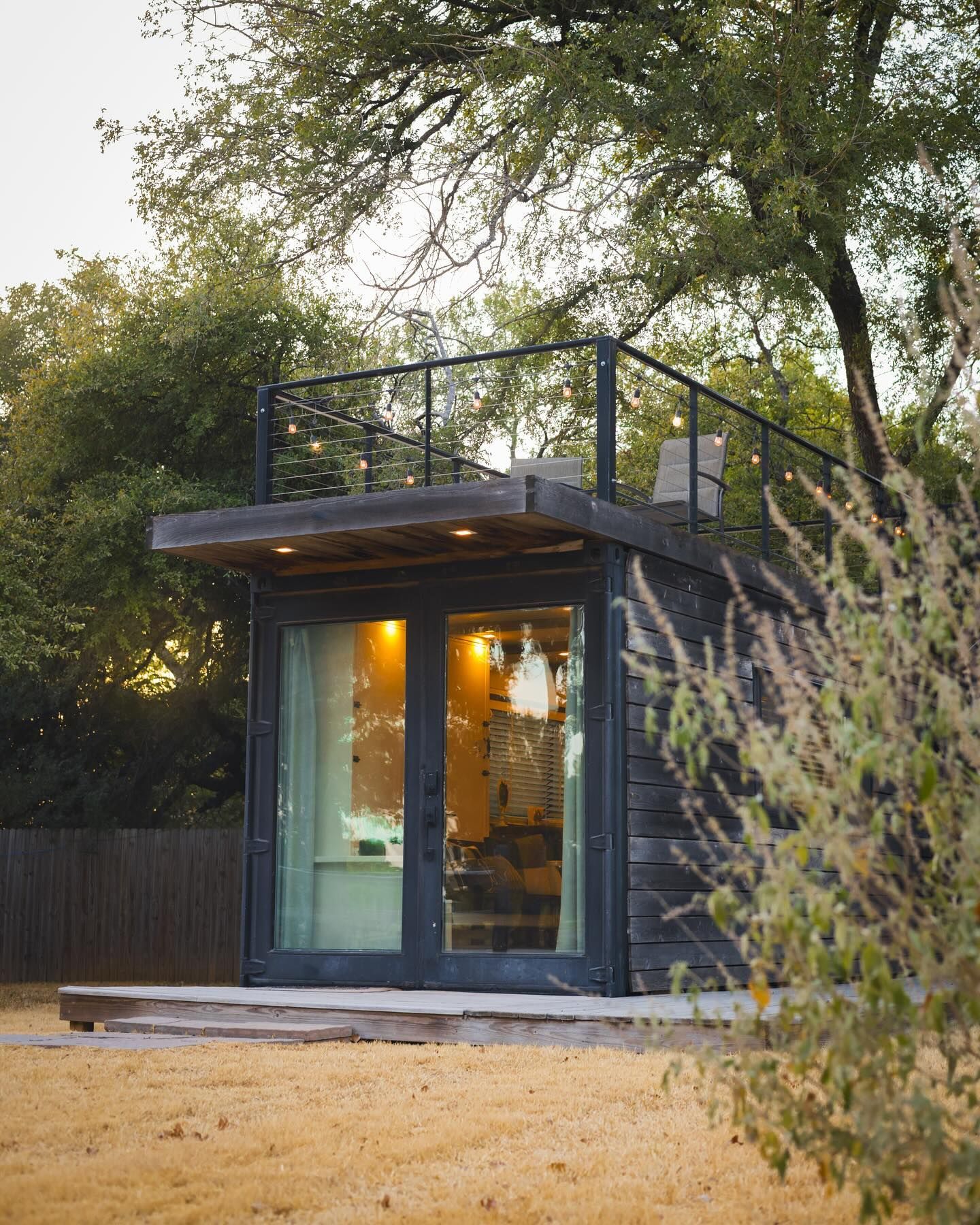 A small house with a balcony on top of it.