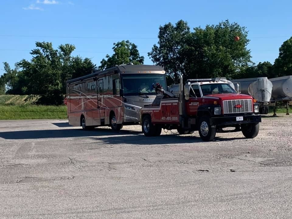 A rv is being towed by a tow truck