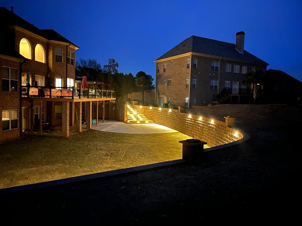 The backyard of a house is lit up at night.